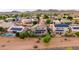Scenic aerial view of a neighborhood home with solar panels, backyard pool, and mountain views at 6971 W El Cortez Pl, Peoria, AZ 85383