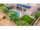Aerial view of a backyard featuring a pool, pergola, and lush landscaping at 6971 W El Cortez Pl, Peoria, AZ 85383