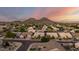 Scenic aerial view featuring landscaped yards, sidewalks, and distant mountain views at 6971 W El Cortez Pl, Peoria, AZ 85383