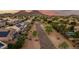 Lush landscaping, sidewalks, and rock drainage system in the neighborhood from an aerial view at 6971 W El Cortez Pl, Peoria, AZ 85383