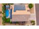 Aerial view of a backyard with a pool, solar panels, and well-manicured landscaping at 6971 W El Cortez Pl, Peoria, AZ 85383