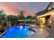 Outdoor living with a pool, waterfall, cabana, and lush landscaping at 6971 W El Cortez Pl, Peoria, AZ 85383