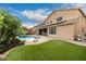 Expansive backyard featuring a pool, lush grass, pergola and an outdoor living area perfect for entertaining at 6971 W El Cortez Pl, Peoria, AZ 85383