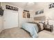 Bedroom featuring neutral paint, plush carpet, large sliding door closet and bed at 6971 W El Cortez Pl, Peoria, AZ 85383