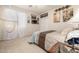 Well-lit bedroom with neutral walls, plush carpet, white curtains, and French art decor at 6971 W El Cortez Pl, Peoria, AZ 85383