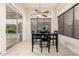 Dining area with a view of the backyard pool and access to outdoor area at 6971 W El Cortez Pl, Peoria, AZ 85383