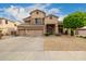 Beautiful home featuring a three-car garage, desert landscaping, and blue sky at 6971 W El Cortez Pl, Peoria, AZ 85383