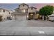 Stunning two-story home with a three-car garage and well-manicured front yard at 6971 W El Cortez Pl, Peoria, AZ 85383