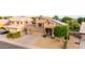 A two-story home with a three-car garage, solar panels, and well-maintained front yard at 6971 W El Cortez Pl, Peoria, AZ 85383