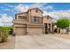 Charming two-story home with a three-car garage, desert landscaping, and charming appeal at 6971 W El Cortez Pl, Peoria, AZ 85383
