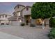 Lovely two-story home showcasing a three-car garage, mature landscaping, and desert charm at 6971 W El Cortez Pl, Peoria, AZ 85383
