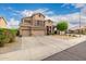 Spacious two-story home with a three-car garage, desert landscaping, and charming curb appeal at 6971 W El Cortez Pl, Peoria, AZ 85383
