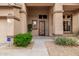 Inviting front entryway with a decorative security door, security system, and lush landscaping accents at 6971 W El Cortez Pl, Peoria, AZ 85383