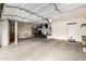 Spacious garage featuring ample storage, an overhead door, and a motorcycle at 6971 W El Cortez Pl, Peoria, AZ 85383