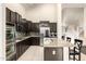 Bright kitchen with stainless steel appliances and a breakfast bar at 6971 W El Cortez Pl, Peoria, AZ 85383