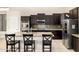 Kitchen with stainless steel appliances, center island, and breakfast bar seating at 6971 W El Cortez Pl, Peoria, AZ 85383