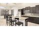 Open kitchen with a center island and stainless steel appliances at 6971 W El Cortez Pl, Peoria, AZ 85383