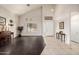 Bright living room with vaulted ceilings, a light color palette, and a harmonious blend of tile and hardwood floors at 6971 W El Cortez Pl, Peoria, AZ 85383