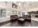 Bright living room featuring vaulted ceilings, large windows, and dark hardwood floors at 6971 W El Cortez Pl, Peoria, AZ 85383