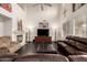 Spacious living room features a fireplace, dark hardwood floors, and vaulted ceilings at 6971 W El Cortez Pl, Peoria, AZ 85383