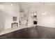 Open concept living room features two-story ceilings and seamlessly connects tile and hardwood flooring at 6971 W El Cortez Pl, Peoria, AZ 85383