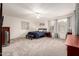 Spacious main bedroom featuring plush carpeting, ceiling fan, and abundant natural light for ultimate comfort at 6971 W El Cortez Pl, Peoria, AZ 85383