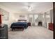 Spacious main bedroom featuring plush carpeting, ceiling fan, and abundant natural light for ultimate comfort at 6971 W El Cortez Pl, Peoria, AZ 85383