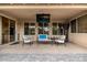 Covered patio featuring comfortable seating, ceiling fan, outdoor TV, and views of the backyard and pool area at 6971 W El Cortez Pl, Peoria, AZ 85383