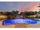 Beautiful pool area with mature landscaping, integrated waterfall feature, and poolside lounge area perfect for outdoor relaxation at 6971 W El Cortez Pl, Peoria, AZ 85383