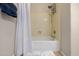 Bright shower featuring a handheld shower head, neutral paint and white shower curtain at 6971 W El Cortez Pl, Peoria, AZ 85383