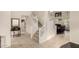 Staircase with neutral tile and white railing leading to an upstairs living area at 6971 W El Cortez Pl, Peoria, AZ 85383
