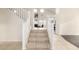 Bright staircase leads to the upper level, complemented by tile flooring, neutral walls, and lots of natural light at 6971 W El Cortez Pl, Peoria, AZ 85383