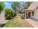 Backyard featuring a covered patio and a well-maintained lawn with lush landscaping and a charming water feature at 732 W Sagebrush St, Gilbert, AZ 85233