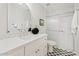 Bathroom featuring a tiled walk-in shower, a toilet, and a white vanity with a modern mirror at 732 W Sagebrush St, Gilbert, AZ 85233
