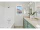 Bright bathroom featuring a shower-tub combo and a vanity with double sinks and stylish fixtures at 732 W Sagebrush St, Gilbert, AZ 85233