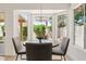 A dining area features a round table, 4 chairs, and large windows offering serene backyard views at 732 W Sagebrush St, Gilbert, AZ 85233