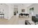 Open-concept living and dining area with a modern table, chandelier, and bright natural light at 732 W Sagebrush St, Gilbert, AZ 85233