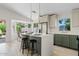 Bright kitchen featuring an island with seating, quartz countertops, and modern appliances with outside views at 732 W Sagebrush St, Gilbert, AZ 85233