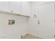 A well-lit laundry room featuring white cabinets, a white door and hookups for a washer and dryer at 732 W Sagebrush St, Gilbert, AZ 85233
