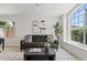 Bright living room featuring a large window, a comfortable sofa, and stylish decor at 732 W Sagebrush St, Gilbert, AZ 85233