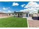 Backyard featuring a covered patio, artificial grass, and a unique pizza oven at 738 S Pomeroy --, Mesa, AZ 85210