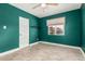 Inviting bedroom boasting green walls, wood floors, and a sunlit window at 738 S Pomeroy --, Mesa, AZ 85210