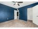 Stylish blue bedroom featuring wood floors, ceiling fan, and a spacious closet at 738 S Pomeroy --, Mesa, AZ 85210