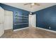 Spacious bedroom with blue walls, wood floors and a well-organized closet at 738 S Pomeroy --, Mesa, AZ 85210