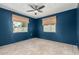 Cozy bedroom featuring stylish blue walls, wood floors, and lots of natural light at 738 S Pomeroy --, Mesa, AZ 85210