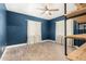 Bedroom featuring stylish blue walls, wood floors, and a modern ceiling fan at 738 S Pomeroy --, Mesa, AZ 85210