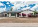 Charming single-story home with a covered carport, flowering bushes and a well-kept front yard at 738 S Pomeroy --, Mesa, AZ 85210