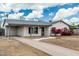 Charming single-story home with a carport, long driveway and xeriscaped front yard at 738 S Pomeroy --, Mesa, AZ 85210