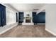 Open living room featuring tiled floors, white brick fireplace with open shelving and a blue accent wall at 738 S Pomeroy --, Mesa, AZ 85210