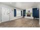 Bright living room featuring wood look tile flooring, white brick fireplace and blue accent wall at 738 S Pomeroy --, Mesa, AZ 85210